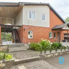 A two-storey house with well-maintained grounds in a peaceful setting surrounded