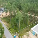 For sale is a 2402 m² plot of land surrounded by a pine forest near Lake Balteze