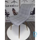 Light gray fabric chairs with gilded legs.