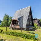 Sunny two-story house with a cultivated plot of land for sale. The foundation of